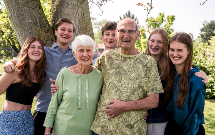Opa en oma met hun kleikinderen op de foto tijdens een familieshoot in de tuin